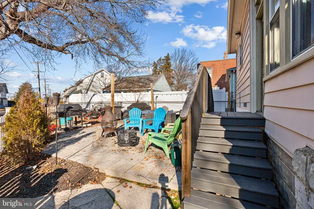 a view of a chairs and table in the backyard