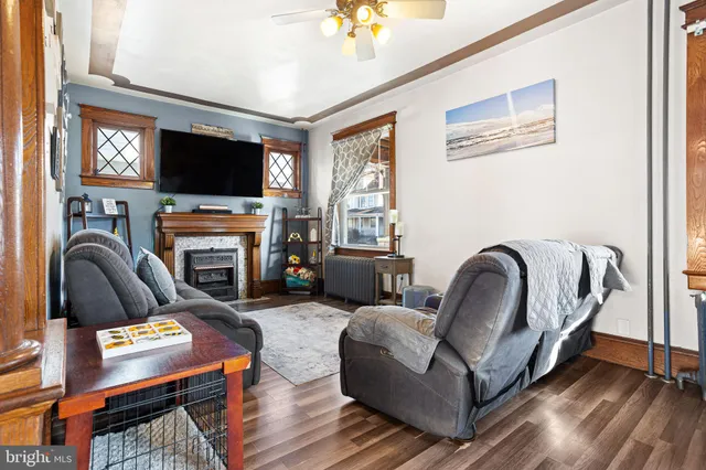 a living room with furniture a flat screen tv and a fireplace