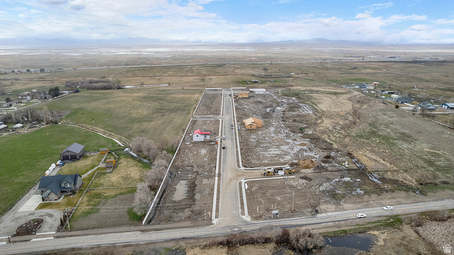1418 West 2350th South, Unit 15 Perry, UT 84302 - Photo 22 of 22 Expansive rural land parcel featuring undeveloped lots, existing residential structures, and a partially constructed home