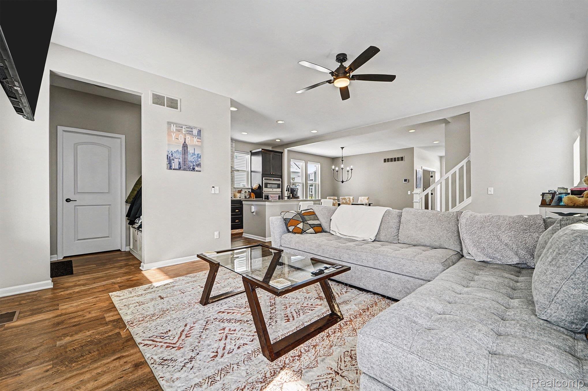 2471 Massoit Road Royal Oak, MI 48073 - Photo 7 of 49 Living area featuring stairway, a chandelier, a ceiling fan, dark wood finished floors, and recessed lighting