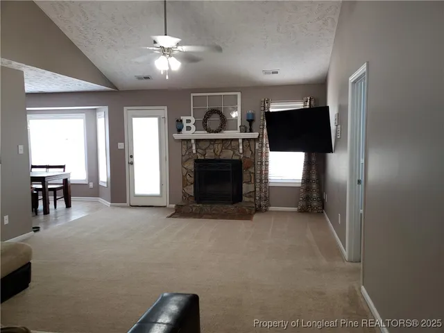 a view of a livingroom with furniture and a fireplace
