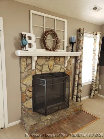 a room with a fireplace and a potted plant