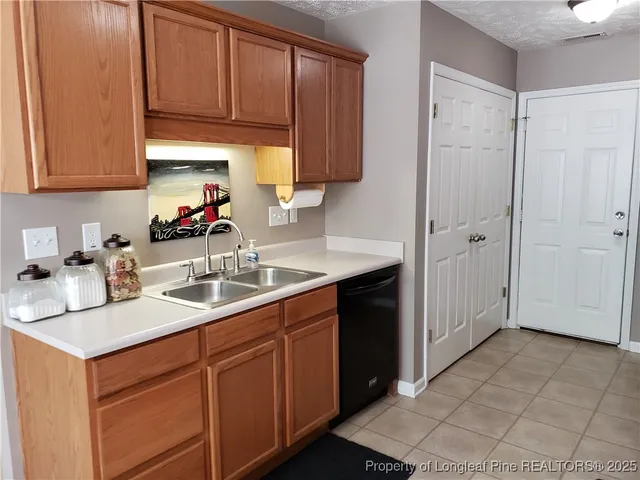 a kitchen with a sink cabinets and utility