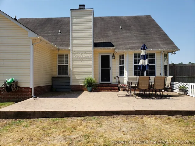 a house view with a outdoor seating