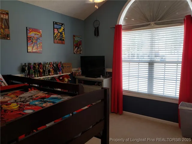 a room with lots of books and a large window