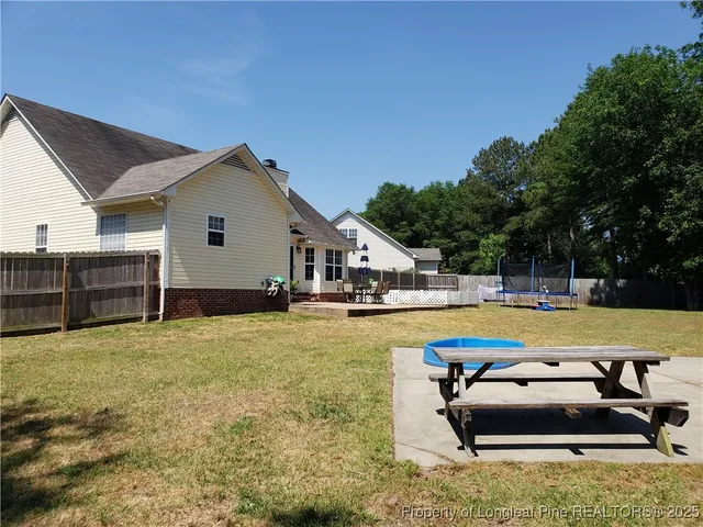 a swimming pool with outdoor seating and yard