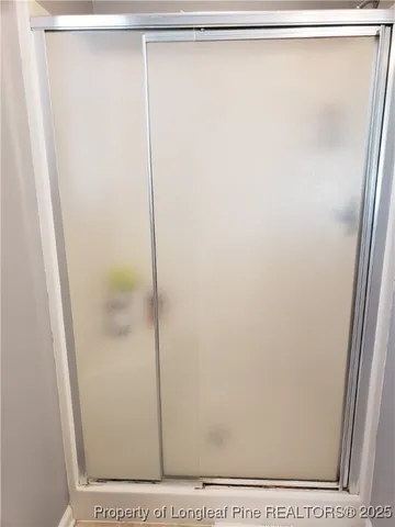 a bathroom with a glass shower door