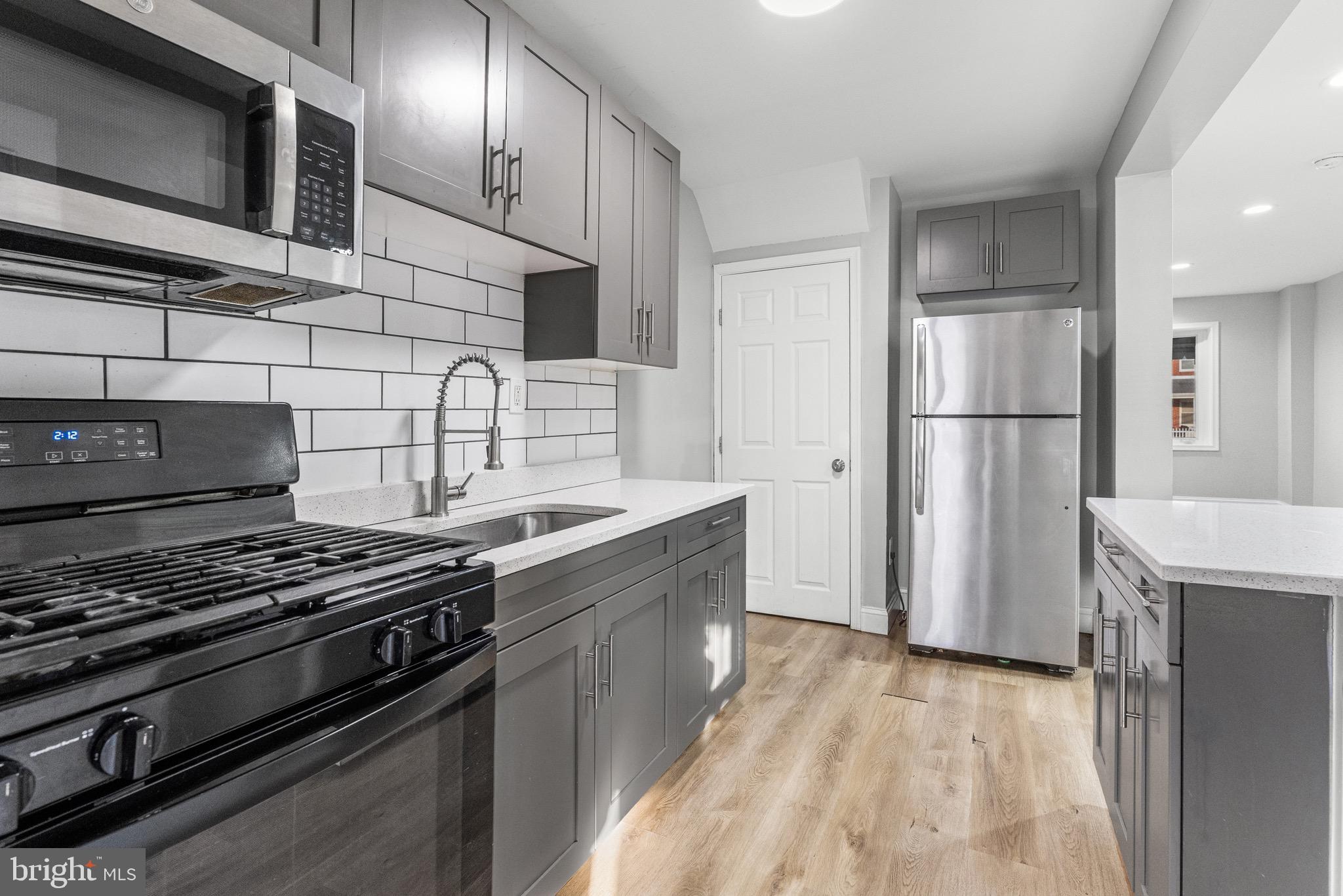 2203 Redthorn Road Baltimore, MD 21220 - Photo 7 of 23 a kitchen with stainless steel appliances granite countertop a stove and a refrigerator