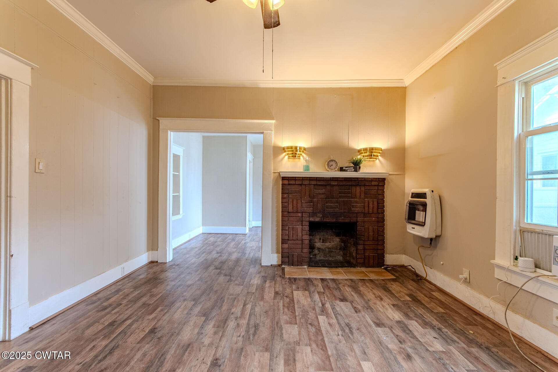 201 North Fairgrounds Street Jackson, TN 38301 - Photo 13 of 27 a view of an empty room with wooden floor fireplace and a window