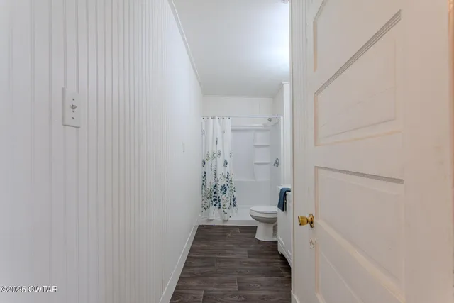 a view of an empty room with fire place and a fireplace