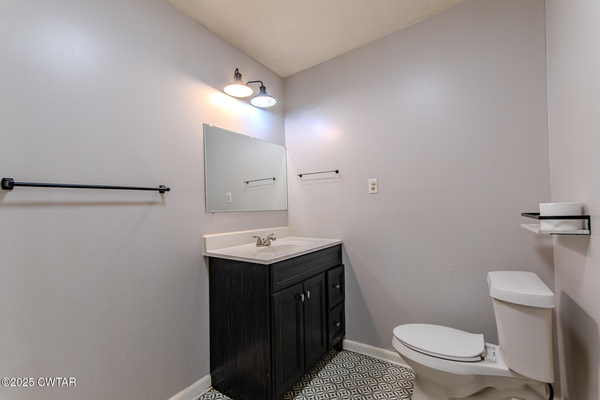 201 North Fairgrounds Street Jackson, TN 38301 - Photo 25 of 27 a bathroom with a sink a toilet a mirror and vanity