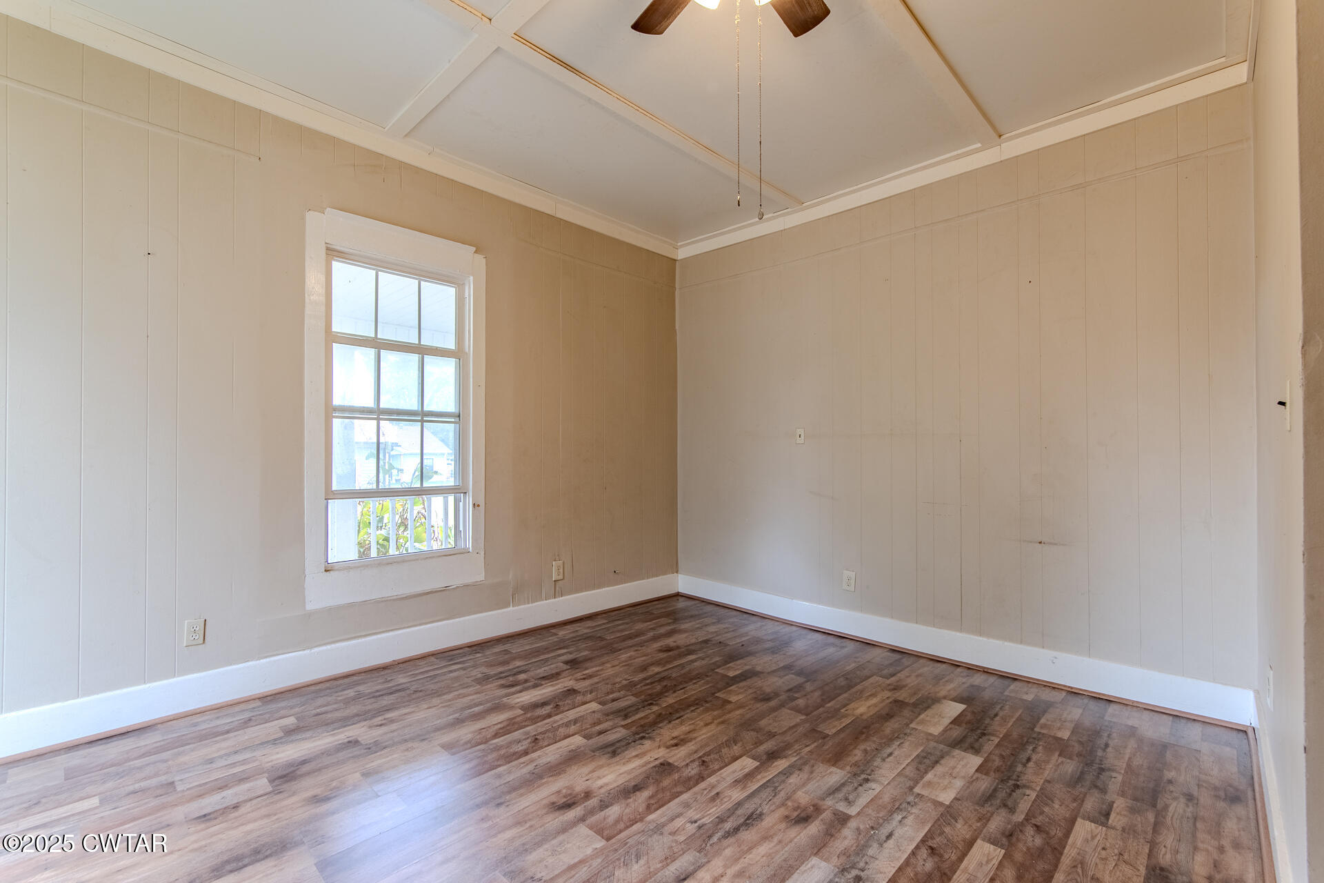 201 North Fairgrounds Street Jackson, TN 38301 - Photo 6 of 27 an empty room with wooden floor and windows