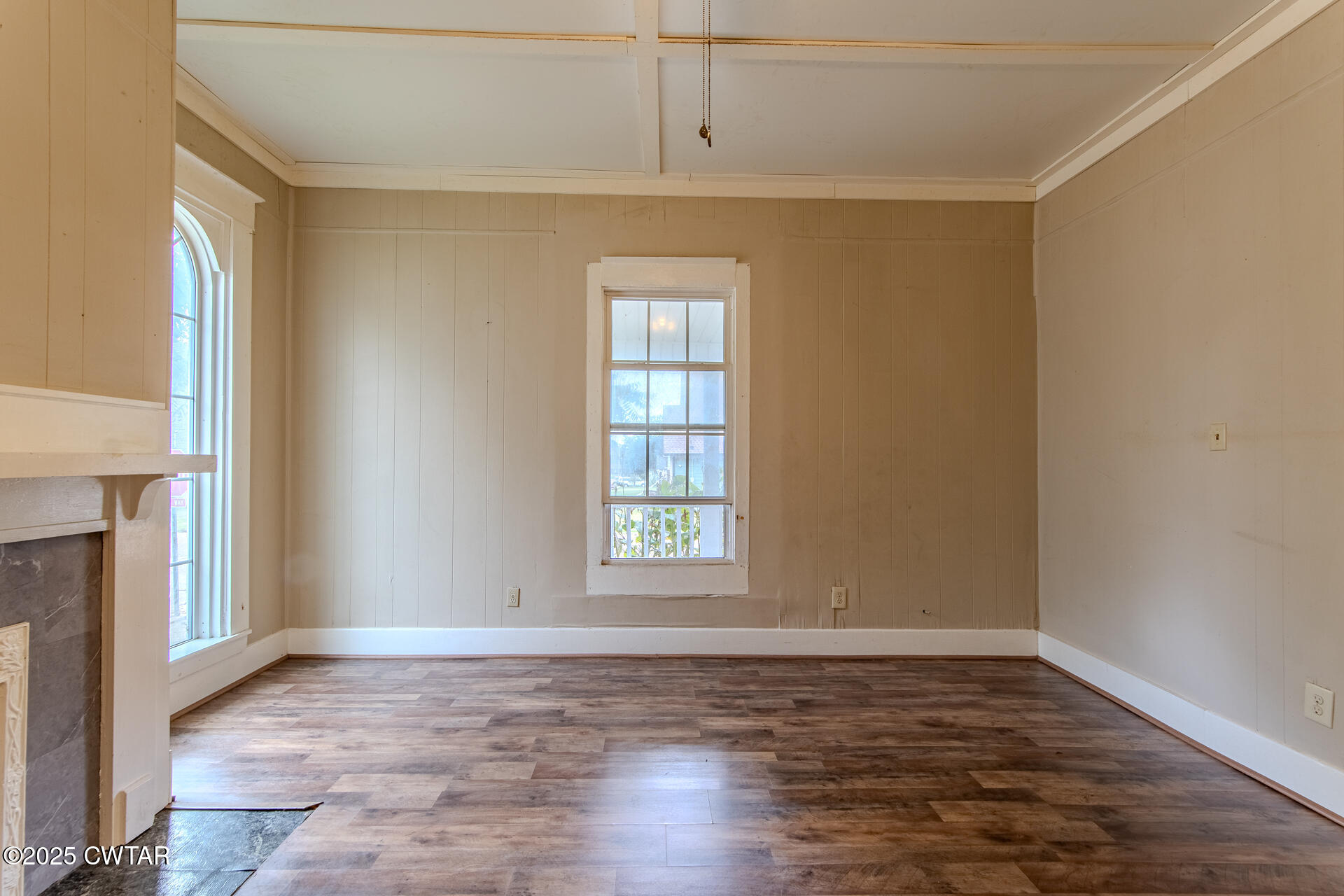 201 North Fairgrounds Street Jackson, TN 38301 - Photo 8 of 27 a view of an empty room with window and wooden floor