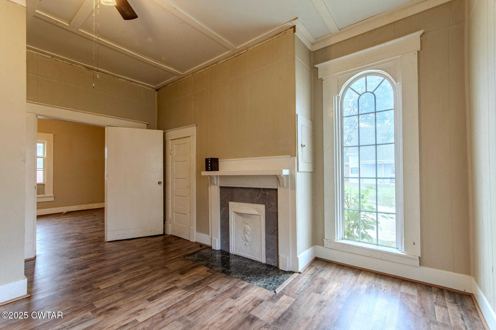 201 North Fairgrounds Street Jackson, TN 38301 - Photo 9 of 27 a view of an empty room with wooden floor fireplace and a window