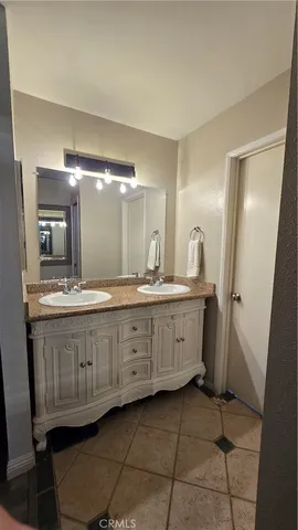 a bathroom with a double vanity sink and a mirror