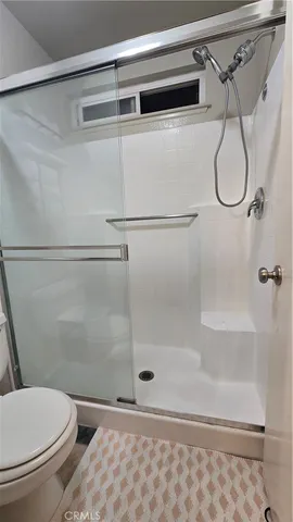 a bathroom with a shower and toilet