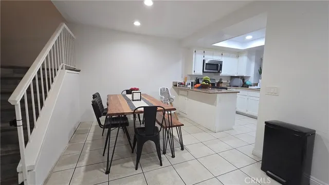 a kitchen with a table chairs and a refrigerator
