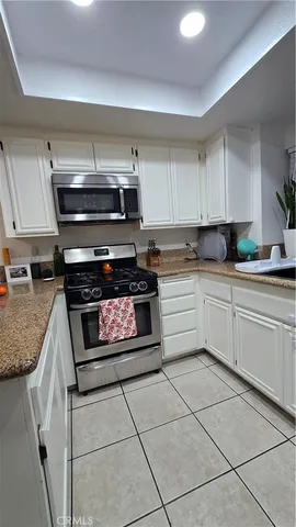 a kitchen with cabinets appliances and a sink