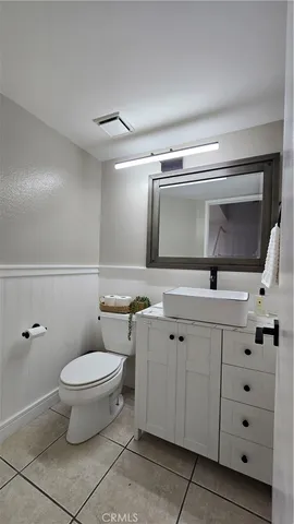 a bathroom with a double vanity sink mirror and toilet