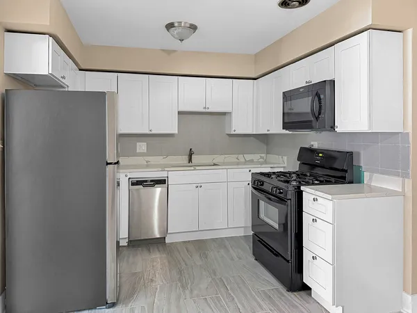 a kitchen with a stove top oven sink and cabinets