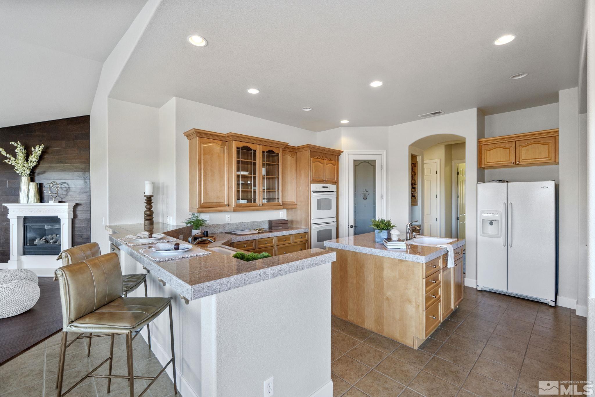 14760 Chateau Avenue Reno, NV 89511 - Photo 12 of 38 a dining hall with stainless steel appliances granite countertop a stove and a refrigerator a oven with the view