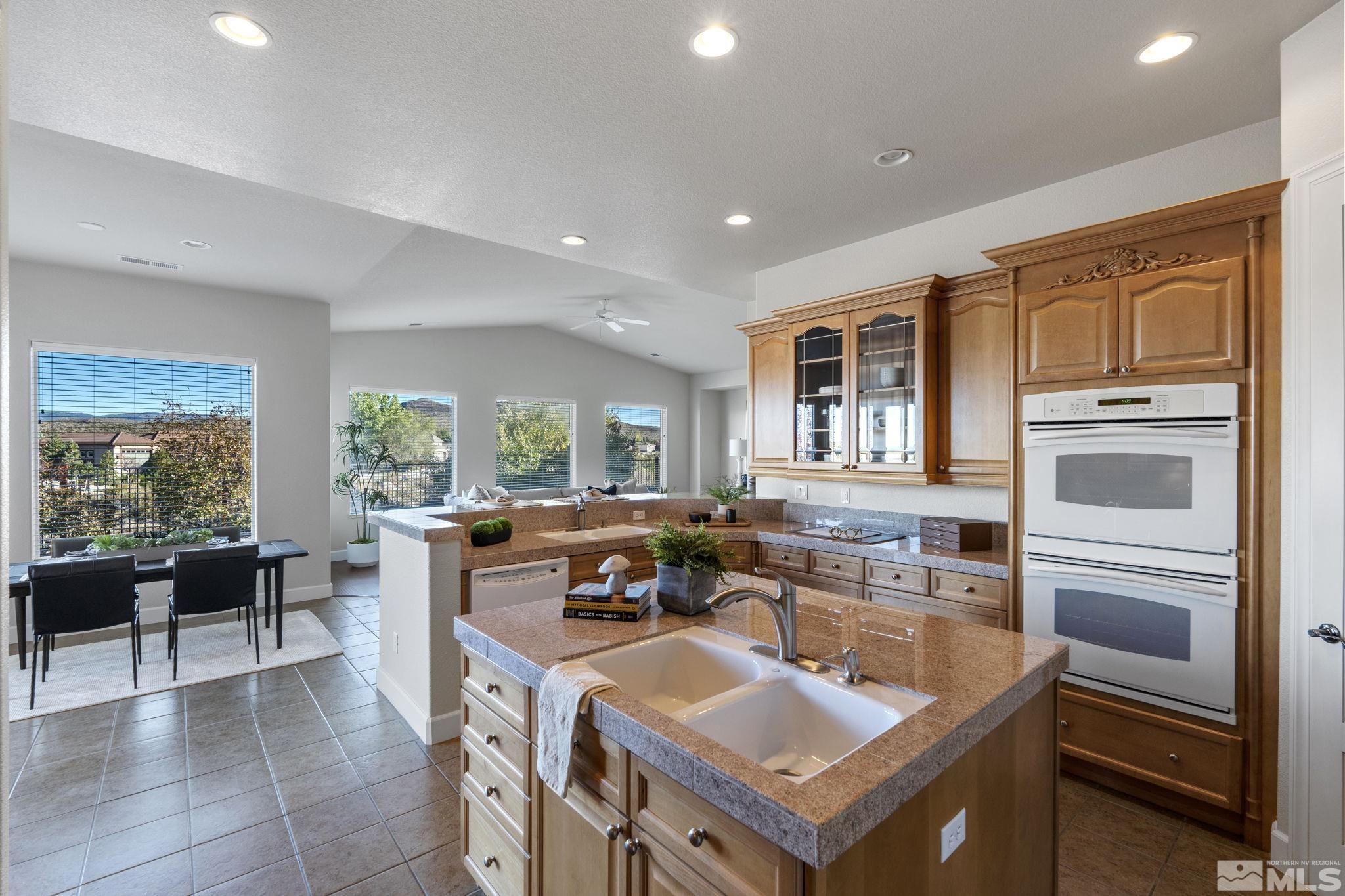 14760 Chateau Avenue Reno, NV 89511 - Photo 15 of 38 a kitchen with stainless steel appliances granite countertop a sink and a refrigerator