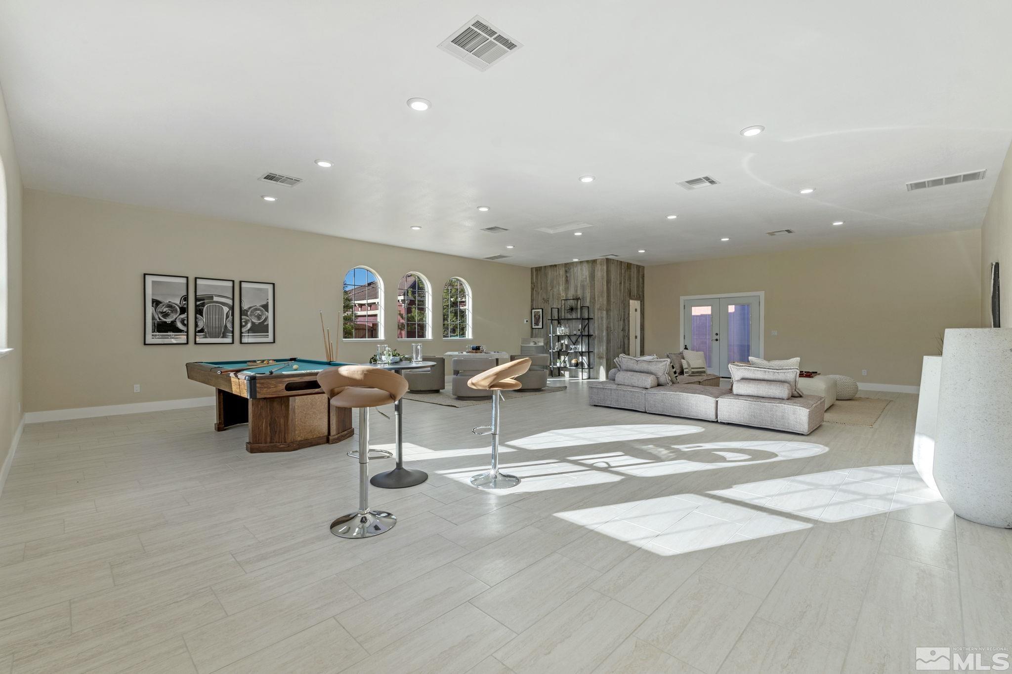 14760 Chateau Avenue Reno, NV 89511 - Photo 27 of 38 a living room with couches and kitchen view with wooden floor