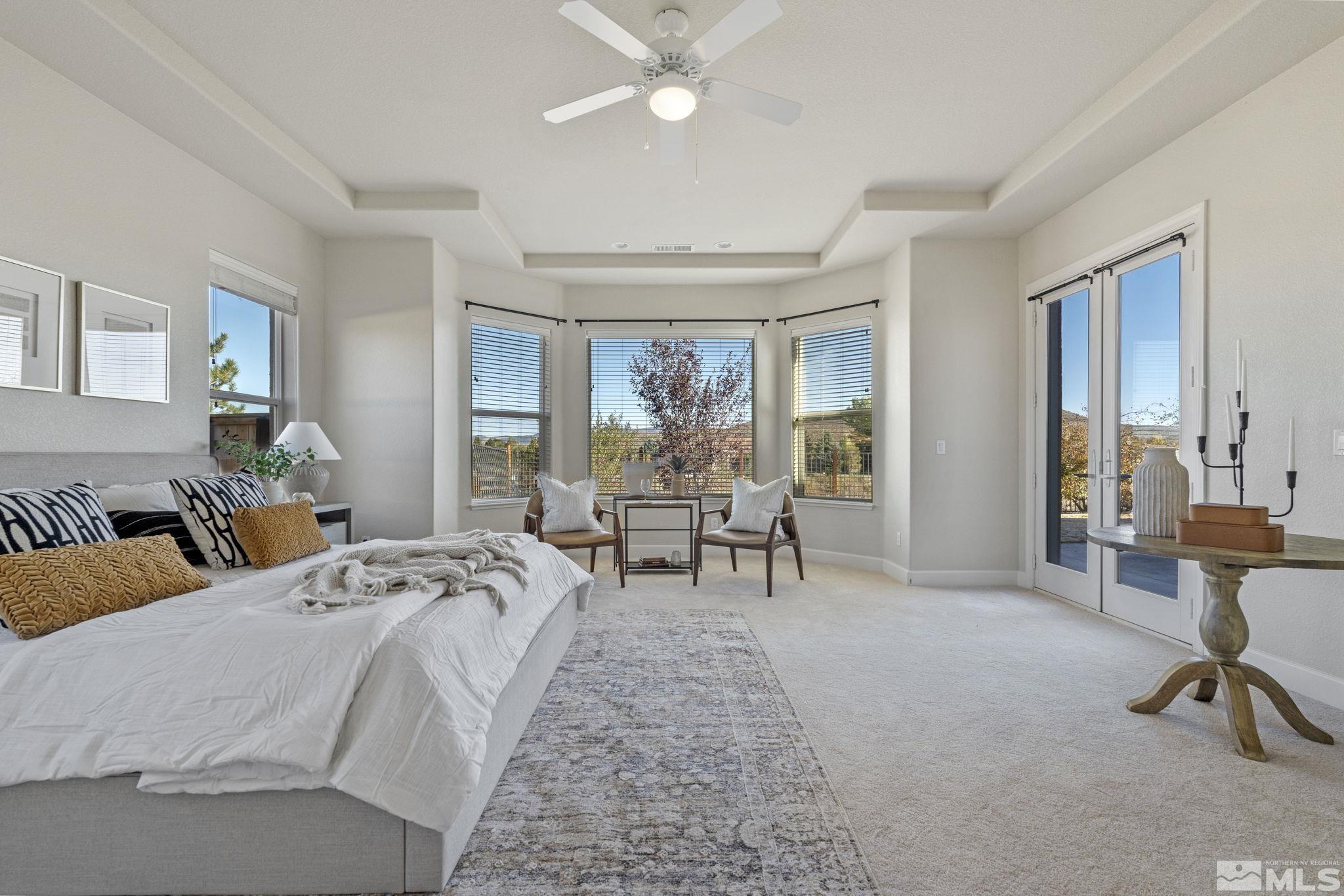 14760 Chateau Avenue Reno, NV 89511 - Photo 30 of 38 a spacious bedroom with a bed a table and chair
