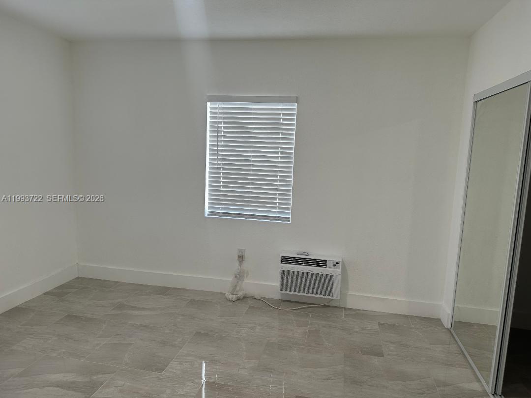 7115 Rue Granville, Unit D Miami Beach, FL 33141 - Photo 11 of 13 an empty room with windows