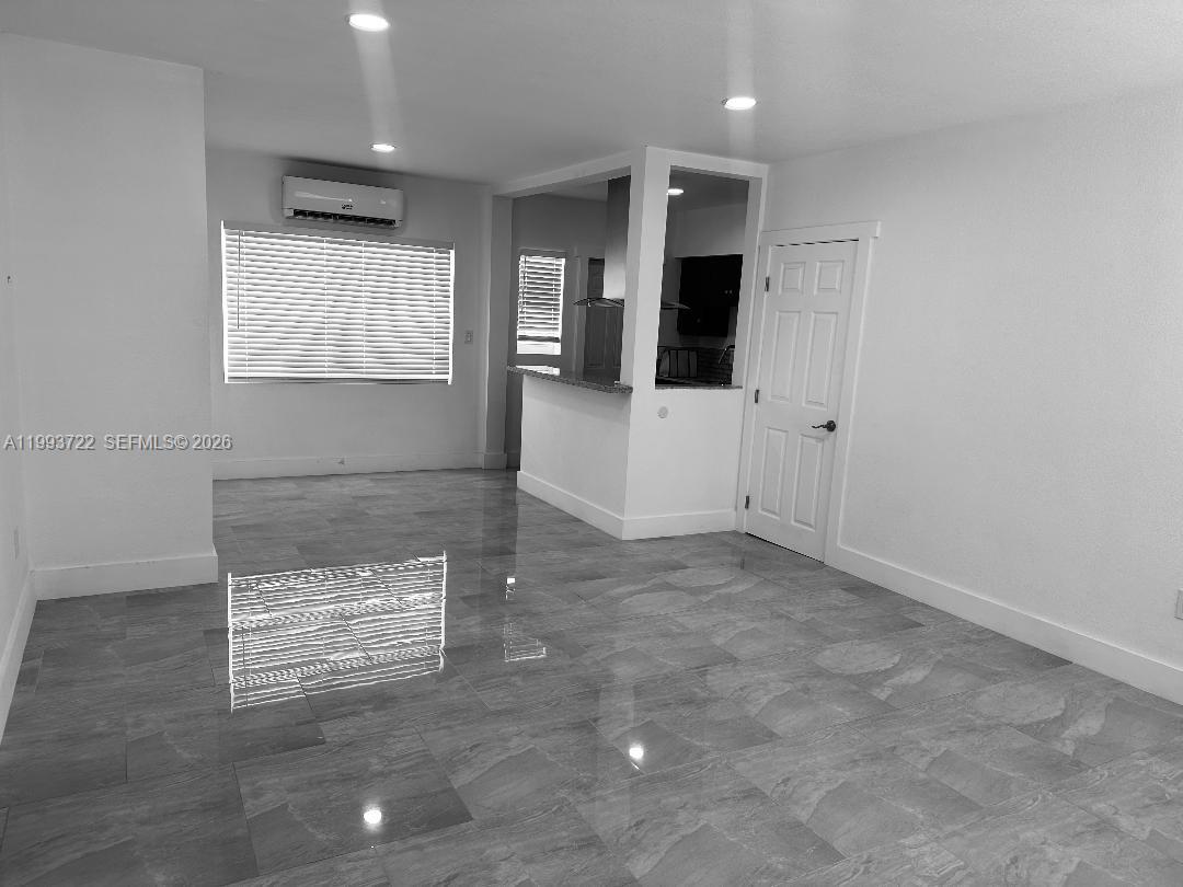 7115 Rue Granville, Unit D Miami Beach, FL 33141 - Photo 3 of 13 a view of an empty room with a window