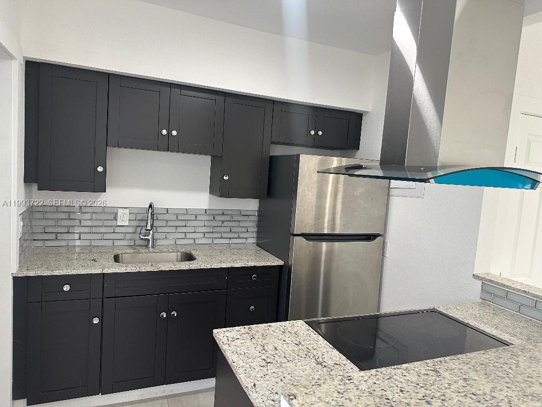 7115 Rue Granville, Unit D Miami Beach, FL 33141 - Photo 5 of 13 a bathroom with a sink and a mirror