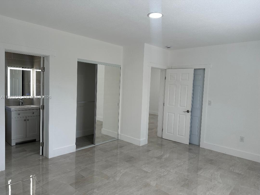 7115 Rue Granville, Unit D Miami Beach, FL 33141 - Photo 6 of 13 an empty room with closet