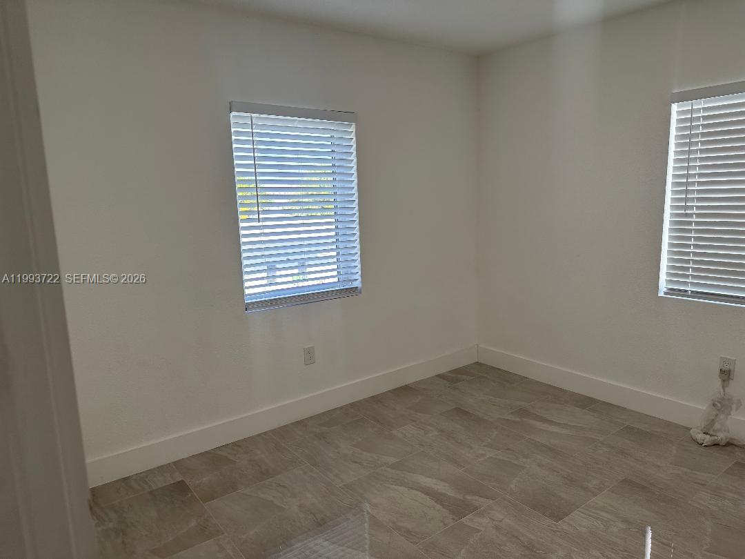 7115 Rue Granville, Unit D Miami Beach, FL 33141 - Photo 8 of 13 an empty room with a window