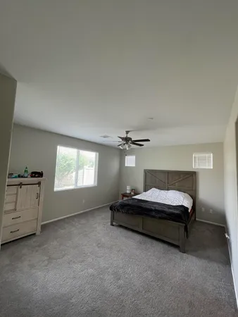a bedroom with two beds and a table