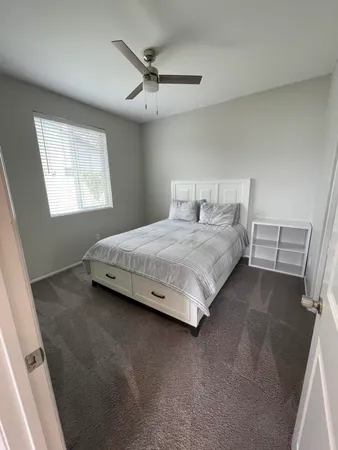 a bedroom with a bed and window