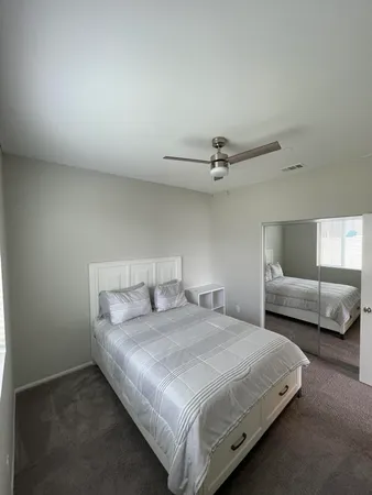 a bedroom with a bed and window