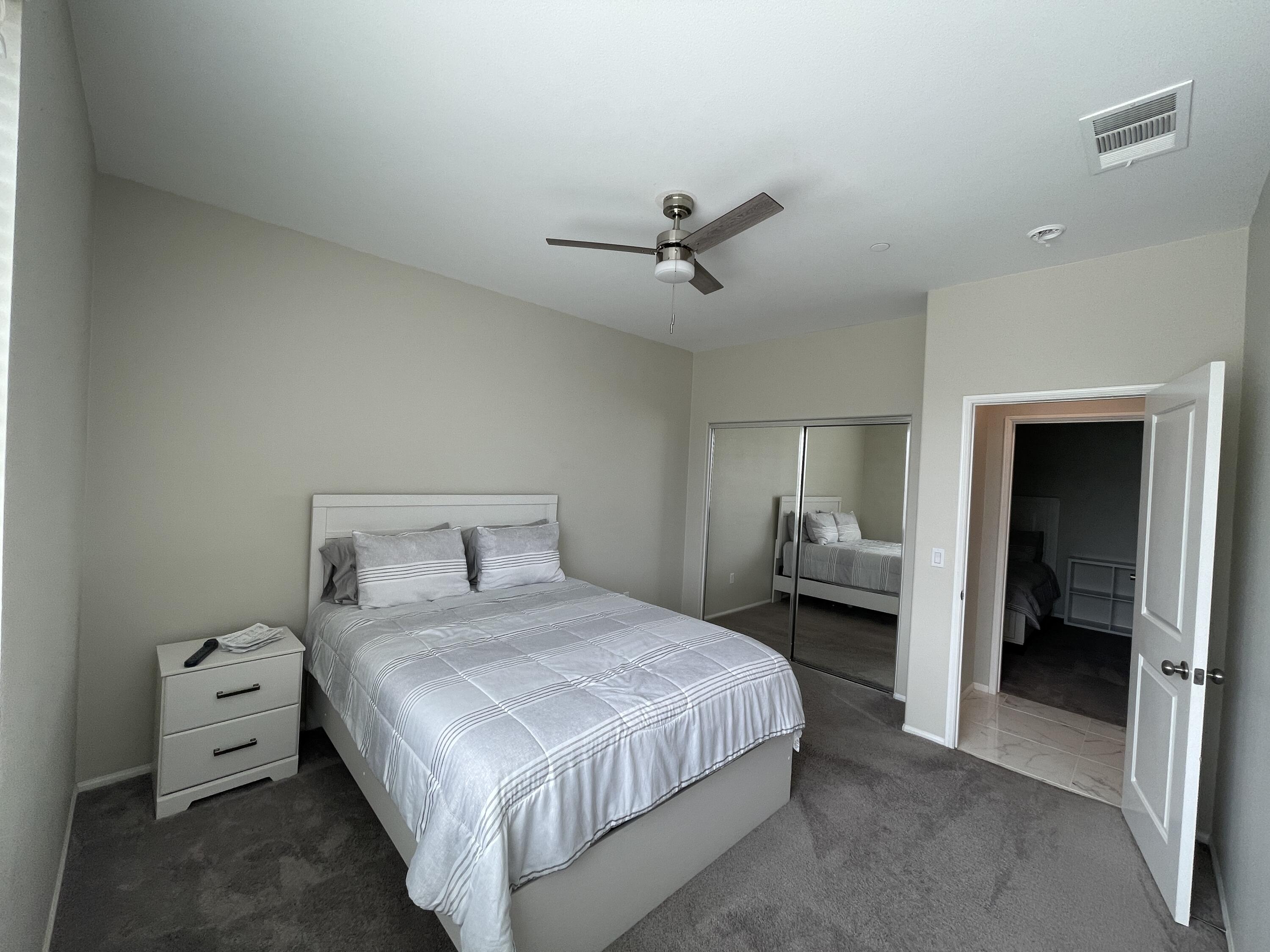 82798 Longfellow Court Indio, CA 92201 - Photo 5 of 15 a bedroom with a bed and a chandelier