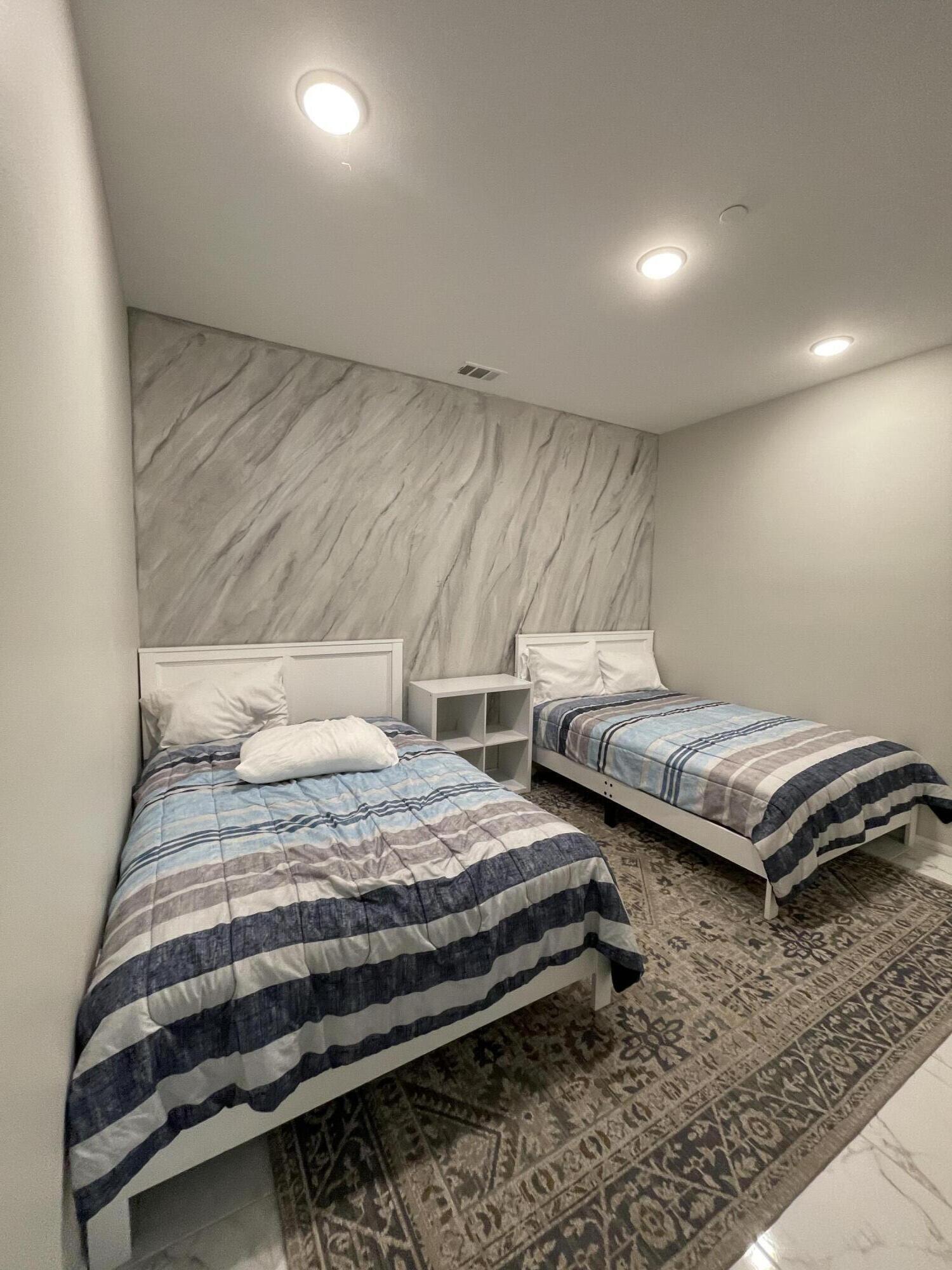 82798 Longfellow Court Indio, CA 92201 - Photo 8 of 15 a bedroom with two beds and a couch