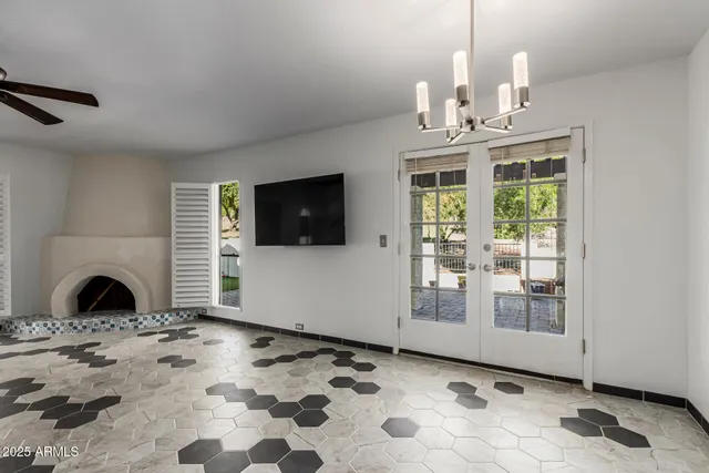 a view of a livingroom with a chandelier a fireplace windows and chandelier