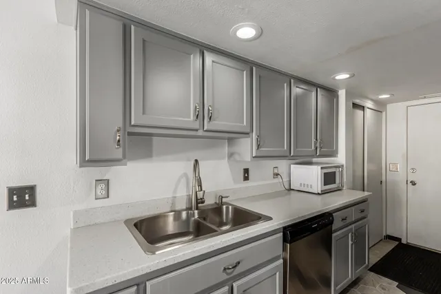 a kitchen with stainless steel appliances granite countertop a sink stove and cabinets