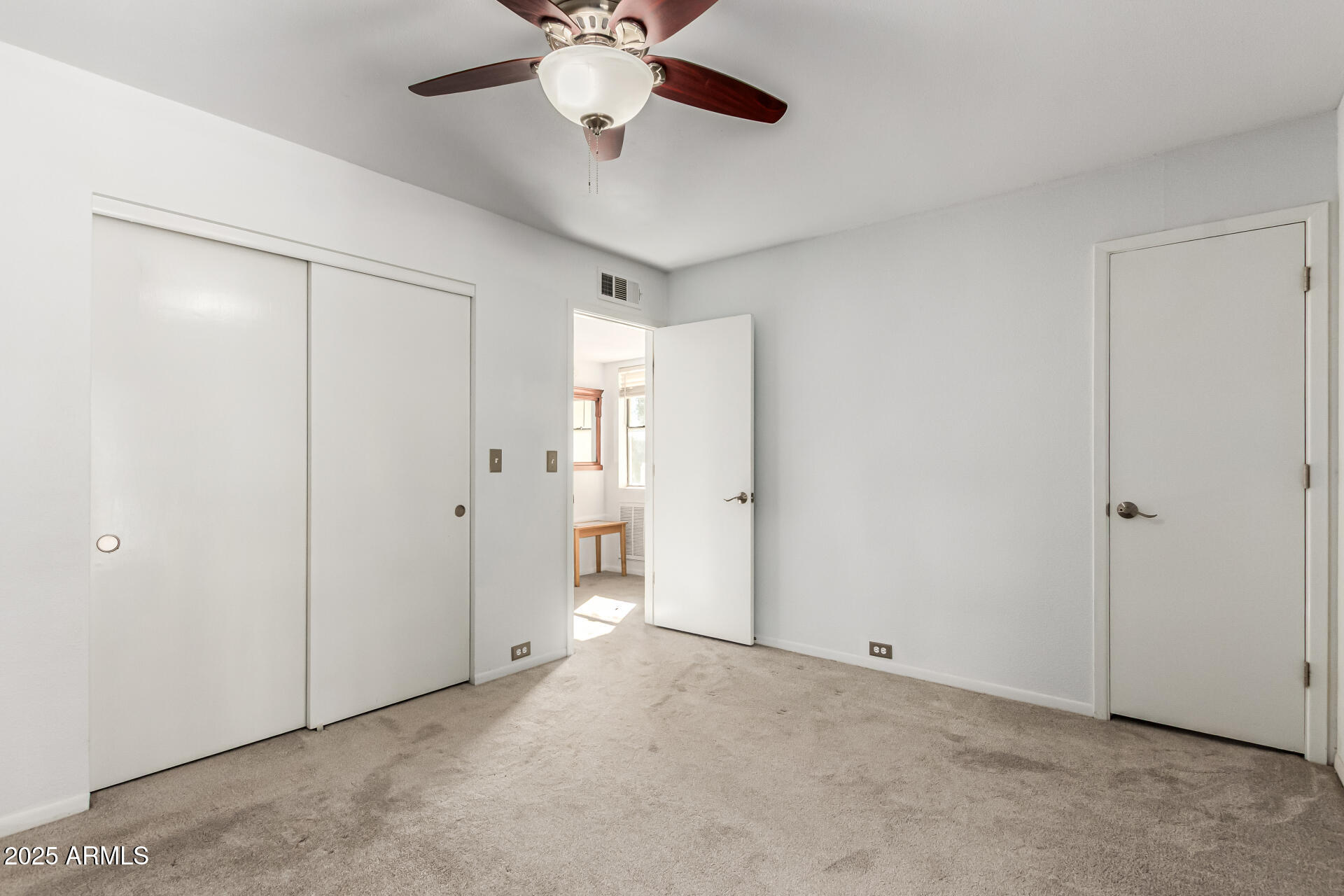 8445 South 48th Street, Unit 2 Phoenix, AZ 85044 - Photo 14 of 32 an empty room with a chandelier fan and windows