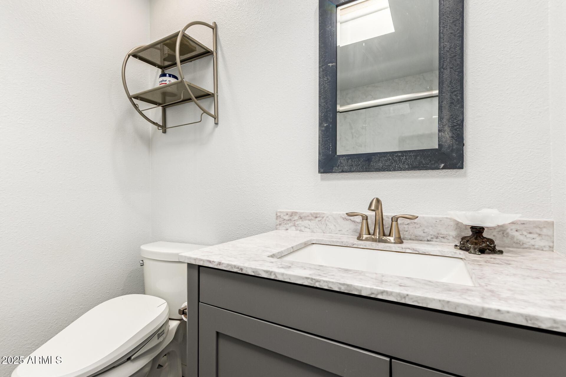 8445 South 48th Street, Unit 2 Phoenix, AZ 85044 - Photo 15 of 32 a bathroom with a toilet sink and mirror