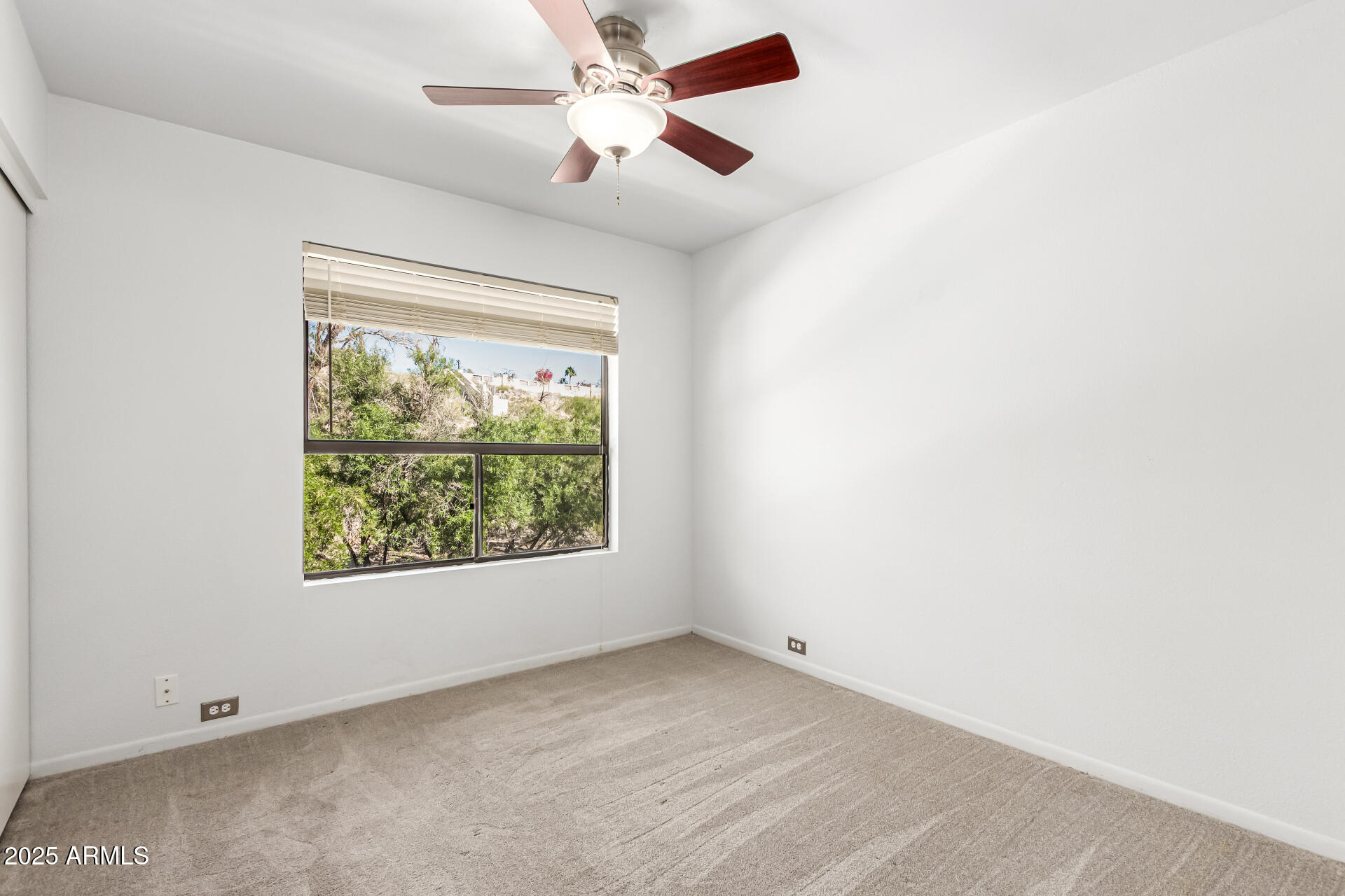 8445 South 48th Street, Unit 2 Phoenix, AZ 85044 - Photo 17 of 32 an empty room with a window and a fan