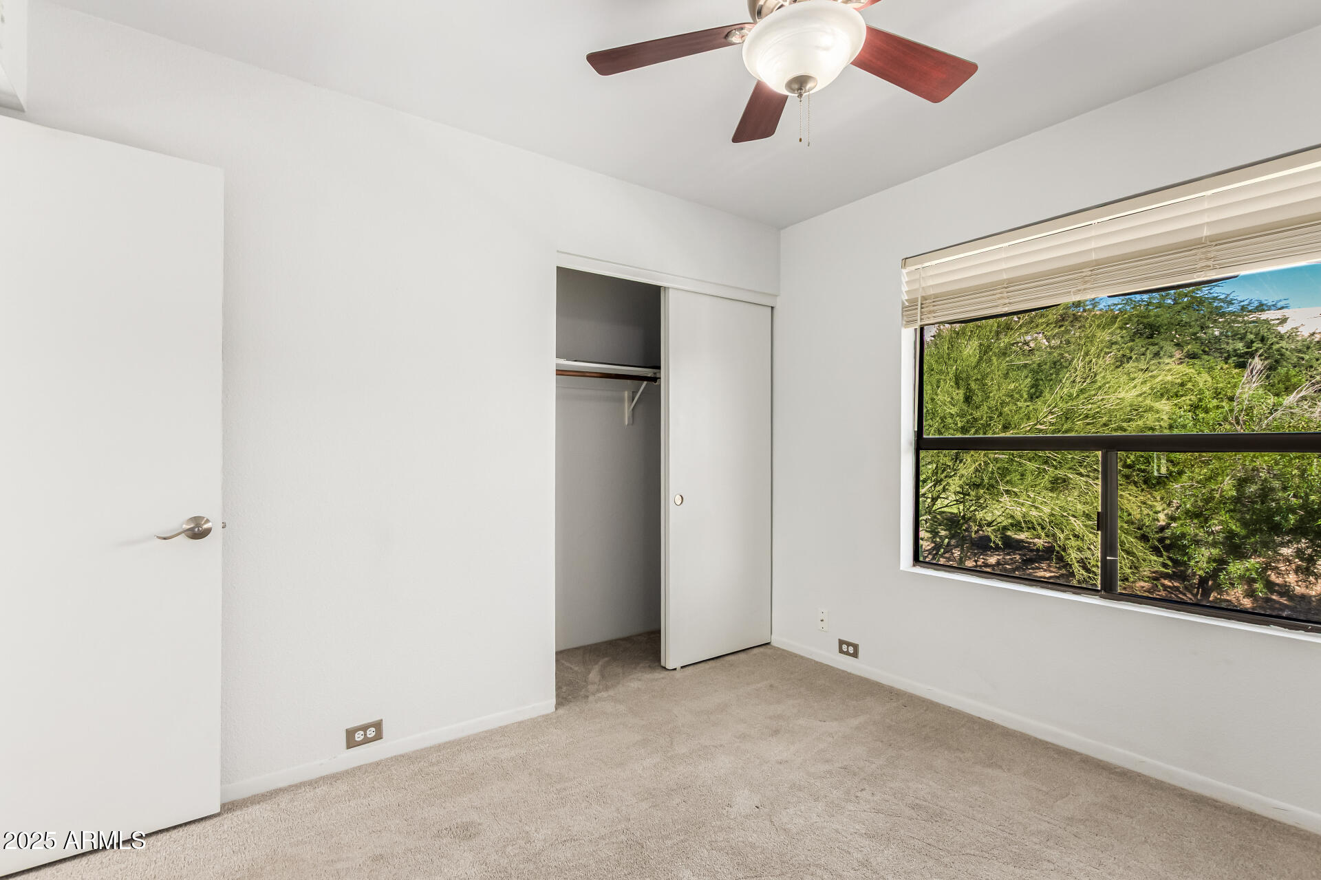 8445 South 48th Street, Unit 2 Phoenix, AZ 85044 - Photo 18 of 32 an empty room with a window and a ceiling fan