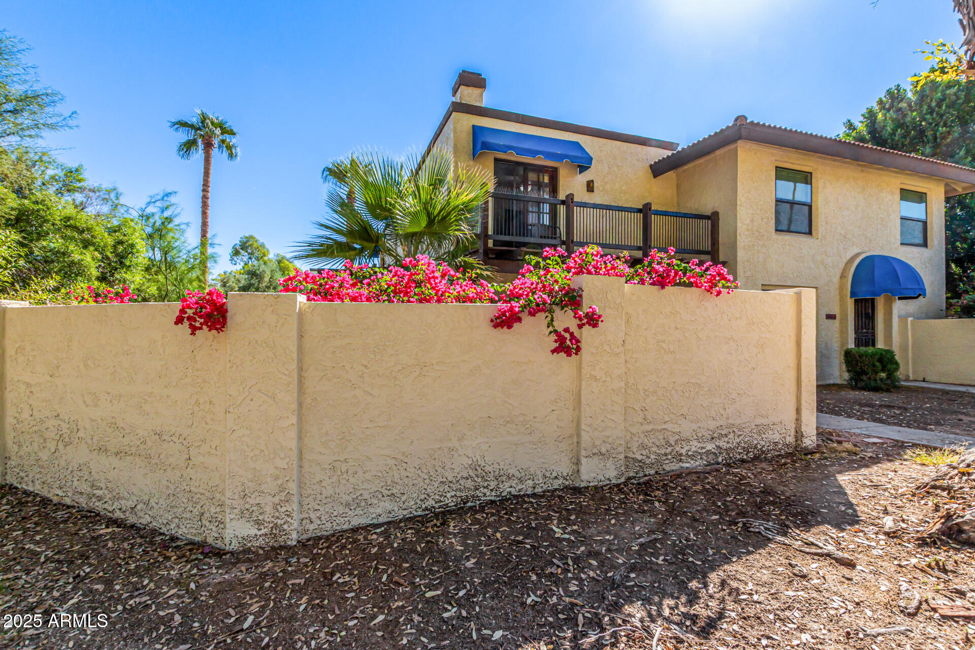8445 South 48th Street, Unit 2 Phoenix, AZ 85044 - Photo 3 of 32 a front view of a house with a yard and a garage