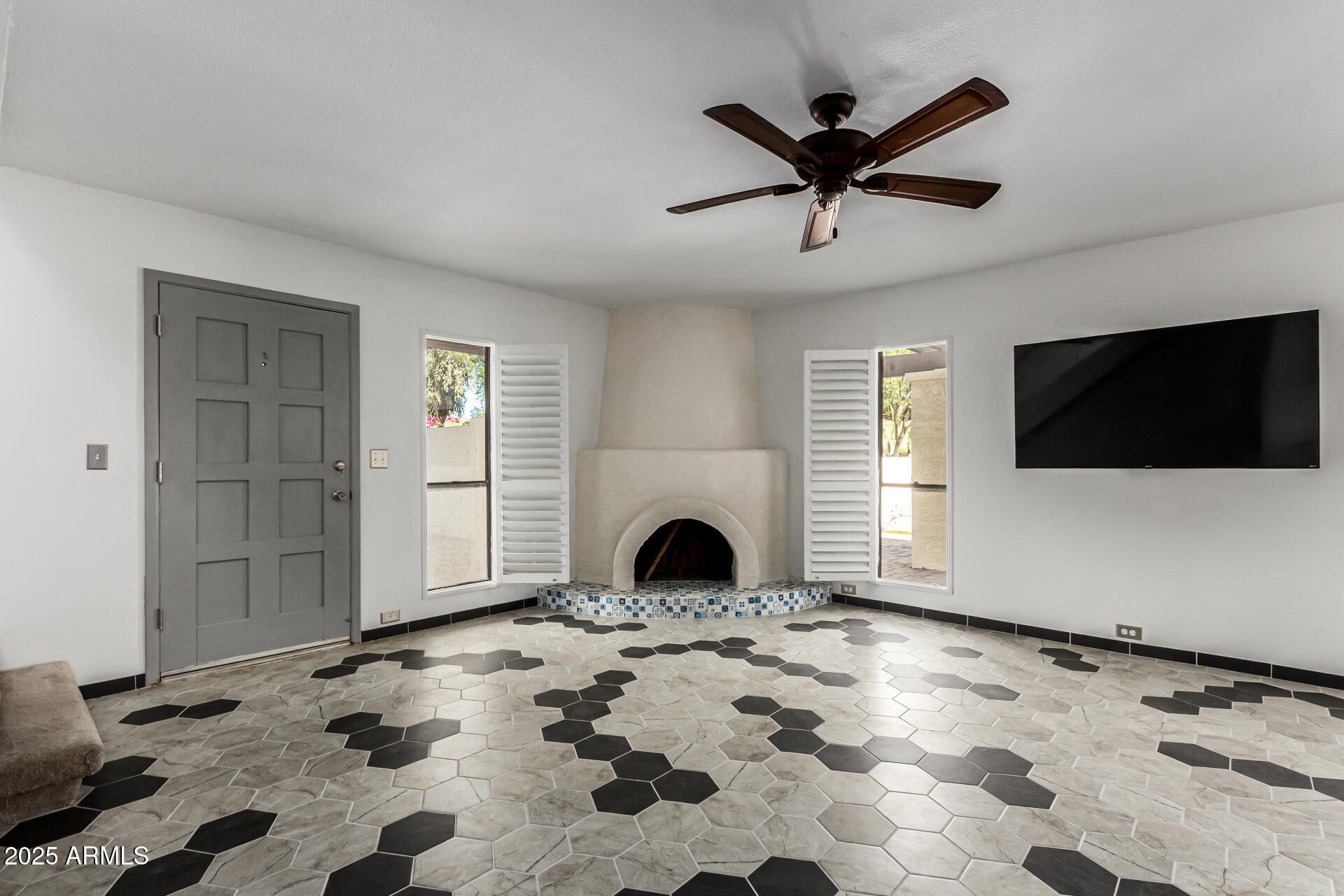 8445 South 48th Street, Unit 2 Phoenix, AZ 85044 - Photo 6 of 32 a view of a livingroom with a fireplace a ceiling fan and wooden floor