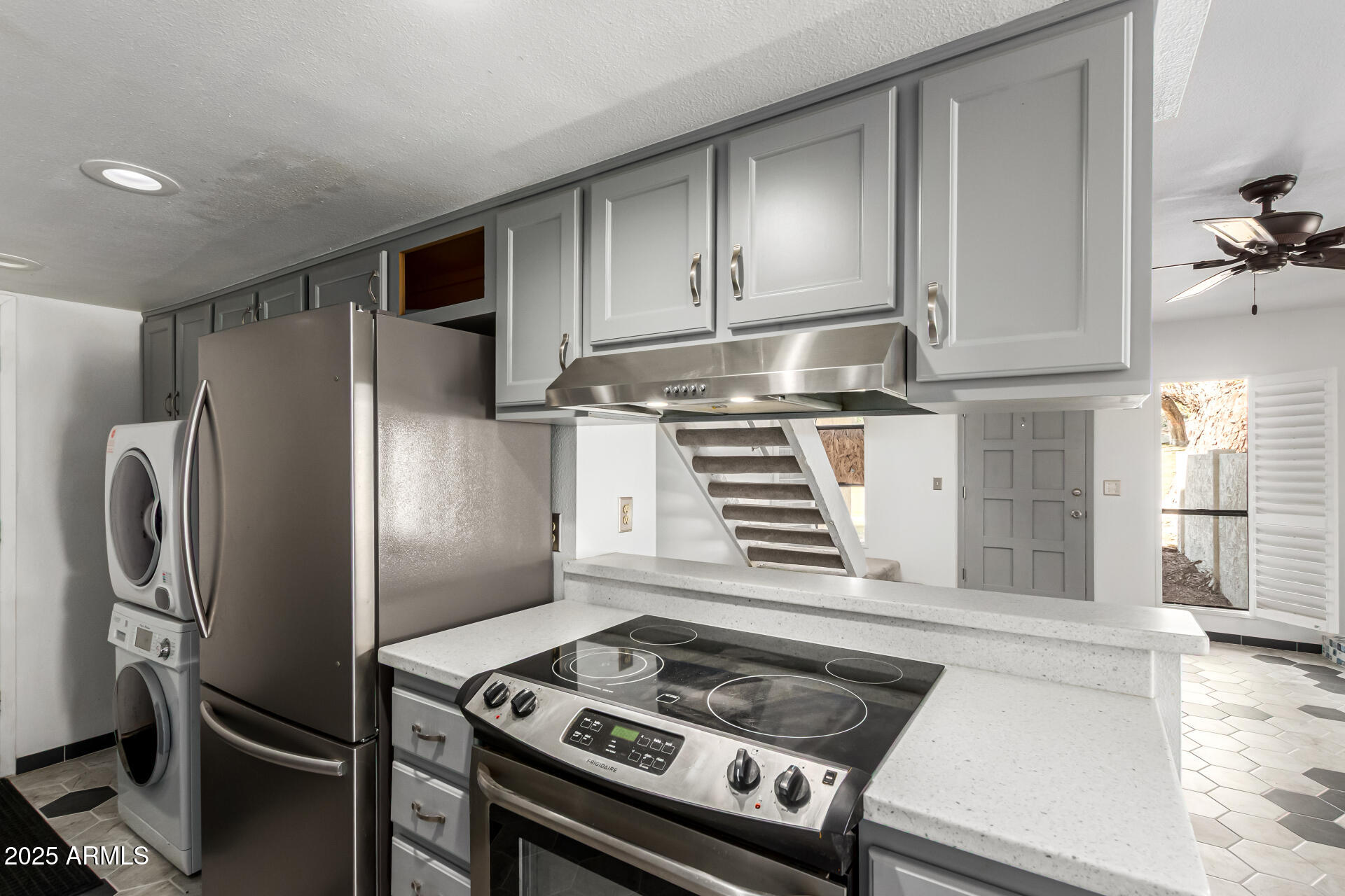 8445 South 48th Street, Unit 2 Phoenix, AZ 85044 - Photo 10 of 32 a kitchen with stainless steel appliances granite countertop a stove and a refrigerator