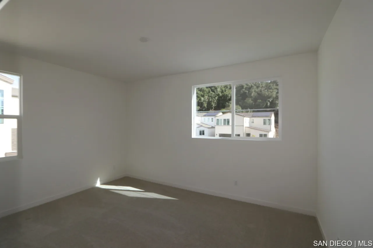 592 Meadowood Street, Unit 405 Fallbrook, CA 92028 - Photo 3 of 9 an empty room with a window