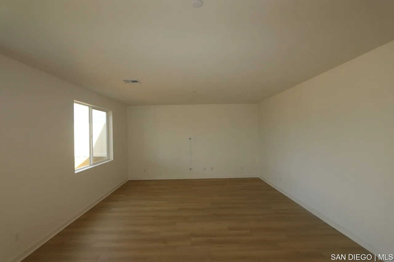 592 Meadowood Street, Unit 405 Fallbrook, CA 92028 - Photo 7 of 9 an empty room with a window