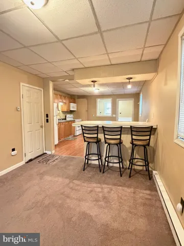 a view of a livingroom with furniture and a window